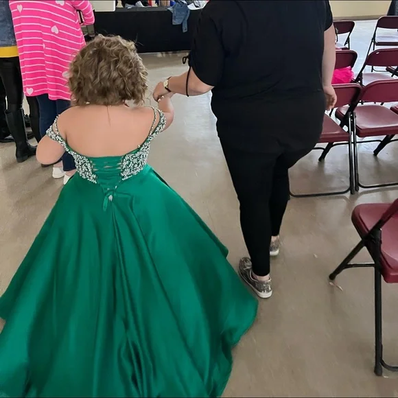 Tiffany size 10. Corset back. It has been hemmed however it can be let out.
